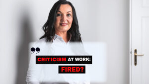 Businesswoman with the headline “Criticism at Work: Fired?” illustrating the career risks employees may face when speaking up.